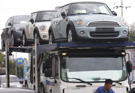 © Reuters. File picture of a truck driver preparing to transport BMW's Mini cars in Goyang