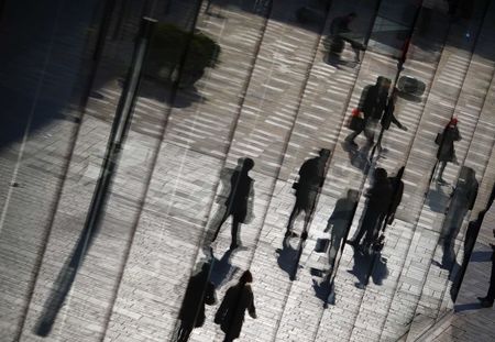 © Reuters. Shoppers are reflected in the window of a retail store in the Taikoo Li Sanlitun fashionable shopping area in Beijing