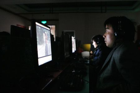 © Reuters. File photo of a man using a computer inside an Internet cafe in Shanghai