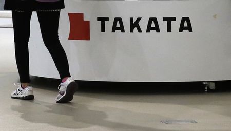 © Reuters. Visitor walks past displays of Takata Corp at a showroom for vehicles in Tokyo