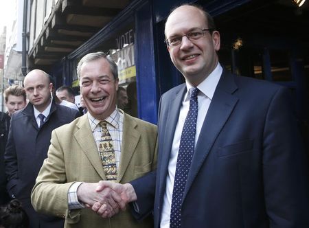 © Reuters. Nigel Farage the leader of the United Kingdom Independence Party (UKIP) shakes hands with Mark Reckless, the former Conservative Party member of Parliament for Rochester and Strood, on polling day in the by-election in Rochester, southern England