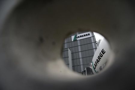 © Reuters. A concrete truck is seen through a hole in a wall at Lafarge concrete production plant in Pantin
