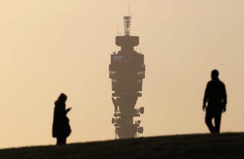 © Reuters. The BT communication tower is seen in the background as people walk on Primrose Hill in London