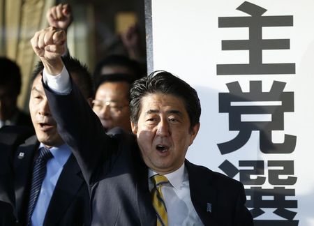 © Reuters. Japan's Prime Minister Shinzo Abe and his party's lawmakers raise their fists as they pledge to win in the upcoming lower house election in Tokyo