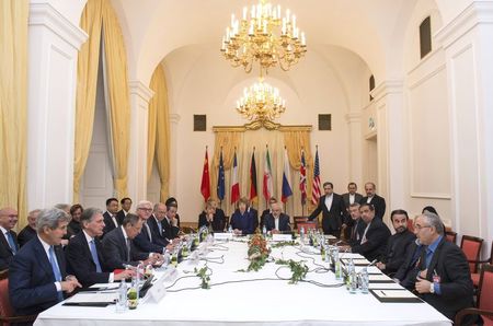 © Reuters. Officials sit around the negotiations table during their meeting in Vienna