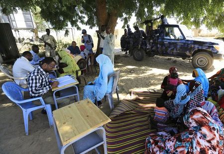 © Reuters. Special Prosecutor for Crimes in Darfur Mohamed and his team talk to women during an investigation into allegations of mass rape in the village of Tabit, in North Darfur