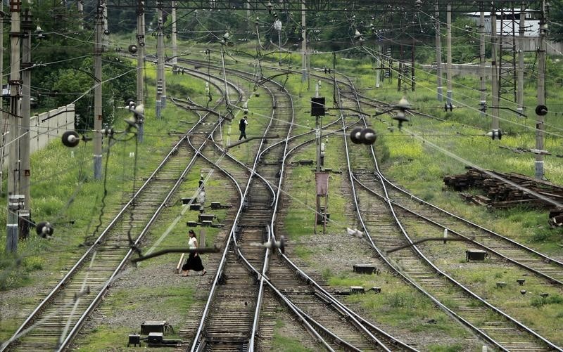 © Reuters. Люди переходят жеоезнодорожные пути в Тбилиси