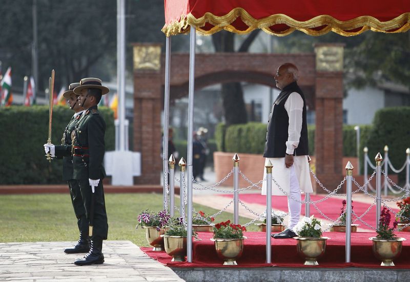 © Reuters. India's Prime Minister Narendra Modi watches a guard of honour upon his arrival for the 18th South Asian Association for Regional Cooperation (SAARC) summit in Kathmandu