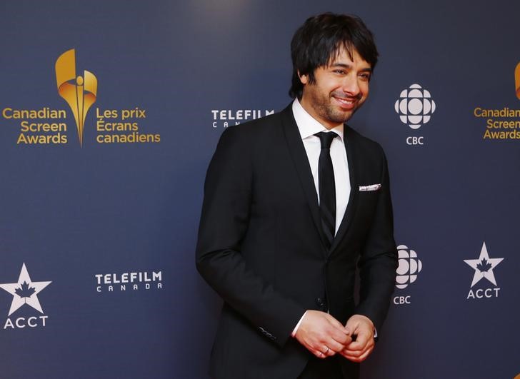 © Reuters. CBC personality Jian Ghomeshi arrives on the red carpet at the 2014 Canadian Screen awards in Toronto