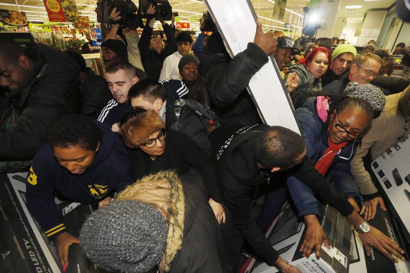 © Reuters. Shoppers compete to purchase retail items on "Black Friday" at an Asda superstore in Wembley