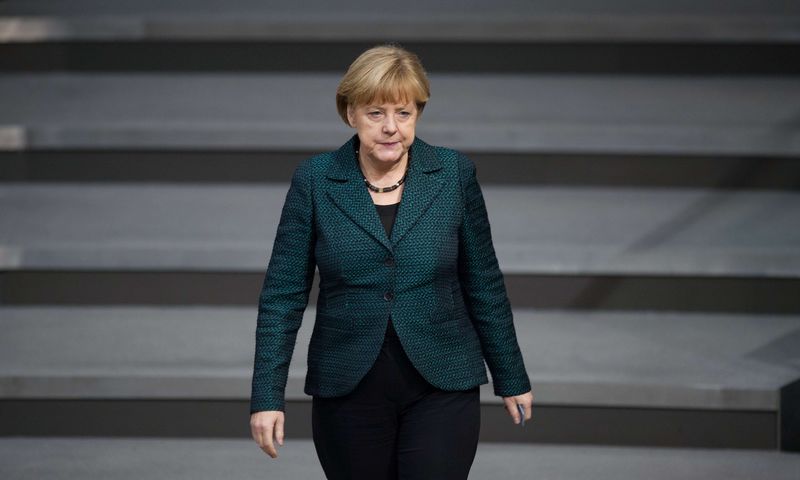 © Reuters. German Chancellor Angela Merkel walks down the stairs in the lower house of parliament Bundestag in Berlin