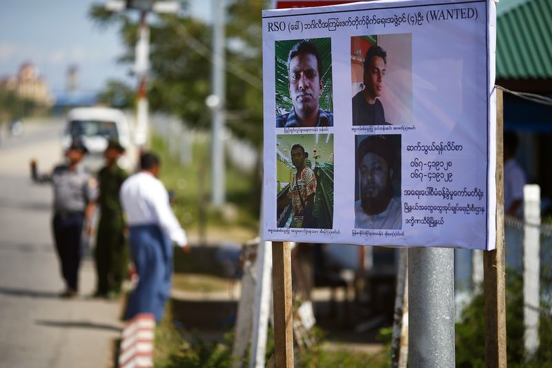 © Reuters. A wanted poster featuring four Rohingya Solidary Organisation suspects is displayed on a check point secured by policemen and soldiers in outskirts of Naypyitaw