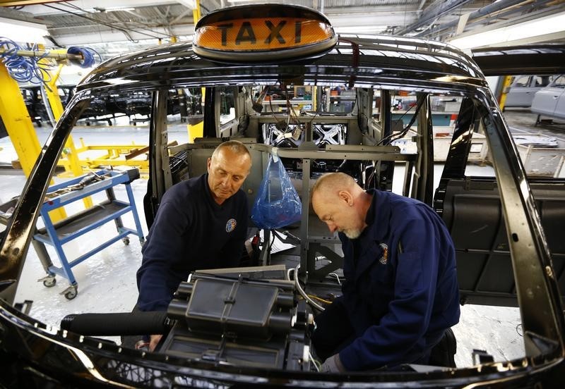 © Reuters. Men work on the production line at the London Taxi Company in Coventry