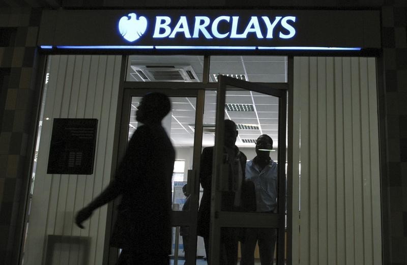 © Reuters. People walk out of a Barclays bank branch inside Barclays Plaza in Nairobi
