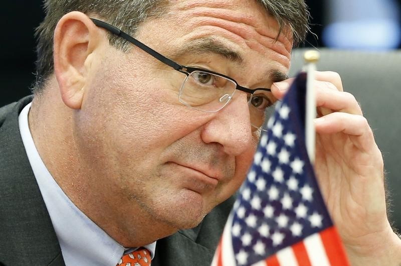 © Reuters. U.S. Deputy Secretary of Defense Carter adjusts his glasses during his meeting with Japanese Senior Vice Defence Minister Watanabe during their meeting in Tokyo