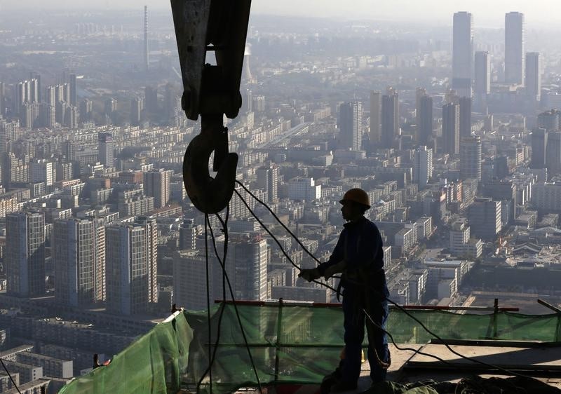 © Reuters. A worker operates at a construction site on the 68th storey of a building in Shenyang