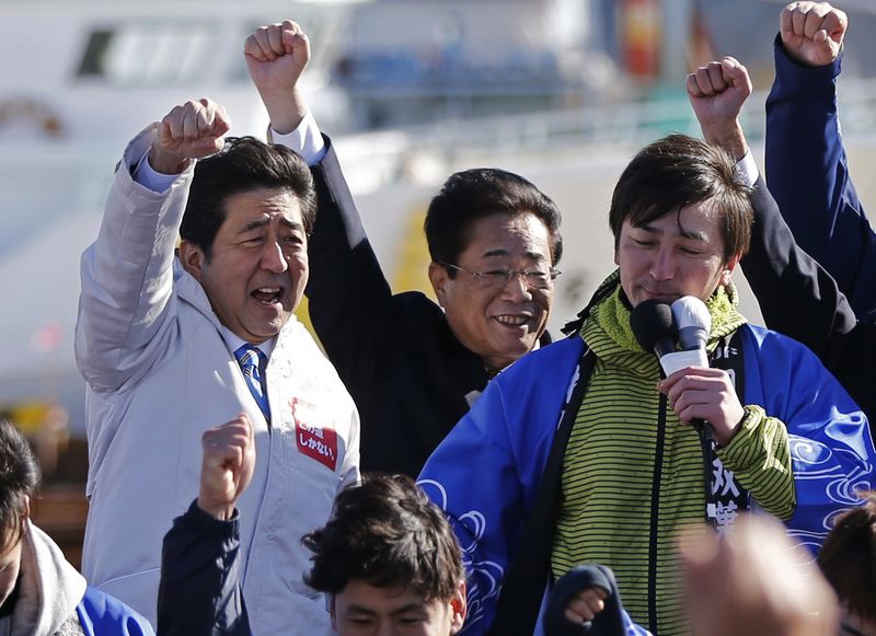 © Reuters. Japan PM Abe raises his fists with LDP party members and supporters during his official campaign kick-off for the Dec 14 lower house election, in Soma