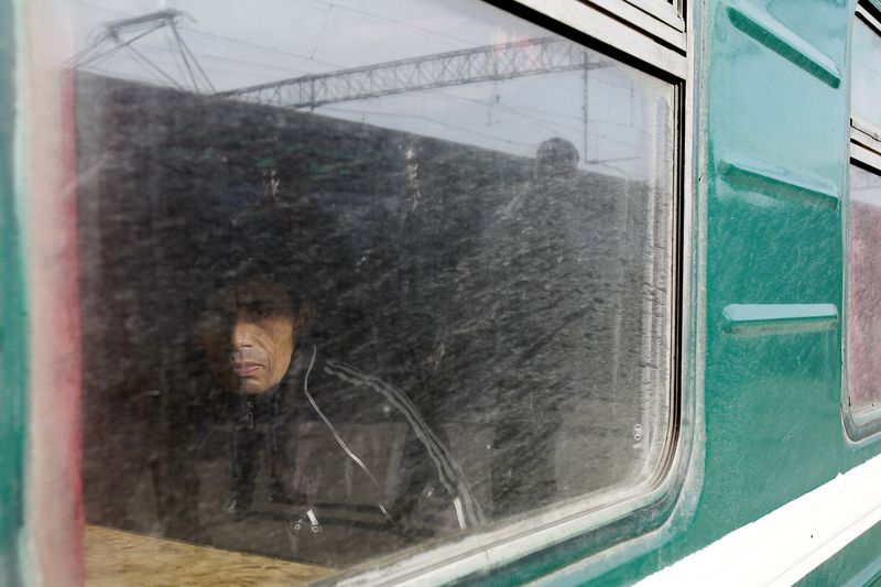 © Reuters. File photo of a migrant worker seen through a carriage window on a train bound for Tajikistan