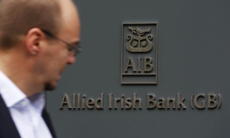 © Reuters. A pedestrian passes a branch of Allied Irish Bank in London