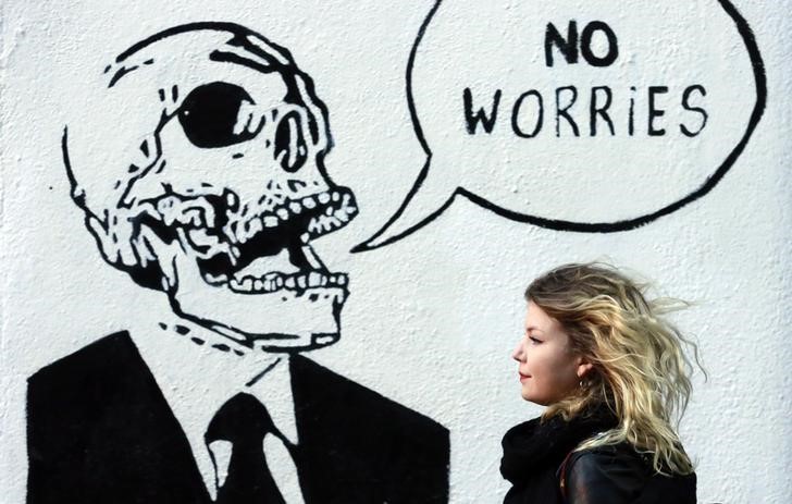 © Reuters. A woman walks past graffiti in the Temple Bar area of Dublin