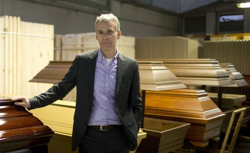 © Reuters. Coffin maker Michael Jagdt (CEO of lignotech Massivholz GmbH) stands in front of coffins in Berlin