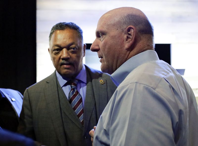 © Reuters. The Reverend Jesse Jackson and former Microsoft Corp Chief Executive Steve Ballmer attend the annual shareholders' meeting in Bellevue, Washington