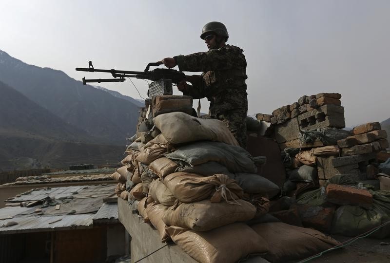 © Reuters.  Afghan National Army (ANA) soldier keeps watch at the Forward Base in Nari district near the army outpost in Kunar