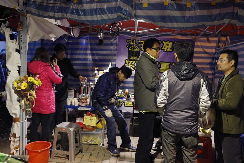 © Reuters. Student leader Joshua Wong, who is on the third day of a hunger strike, rests in a tent outside the government headquarters in Hong Kong