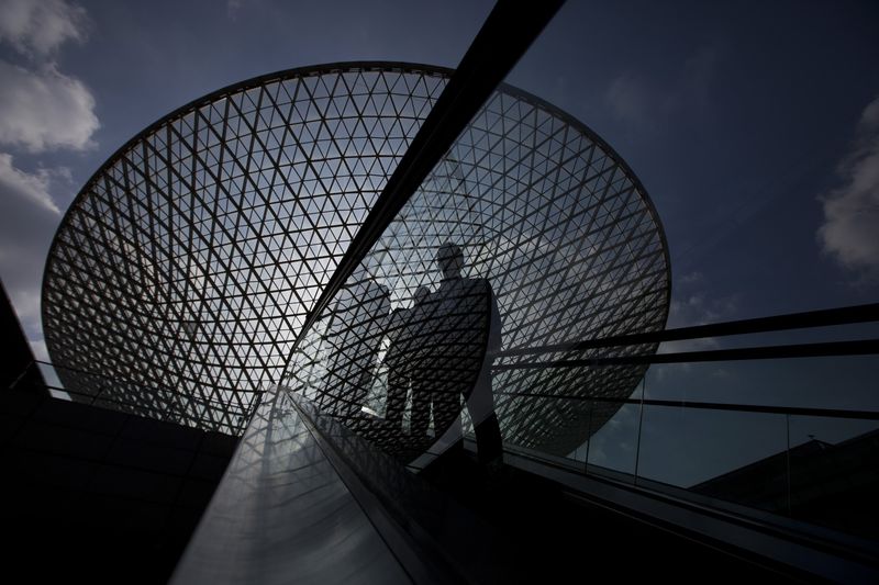 © Reuters. People ride an escalator near the Expo Axis in Shanghai