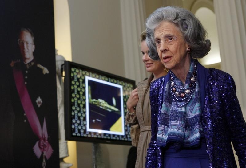 © Reuters. Belgium's Queen Fabiola walks past a portrait of her late husband King Baudouin I on King's Day in Brussels