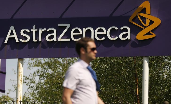 © Reuters. busA man walks past a sign at an AstraZeneca site in Macclesfield