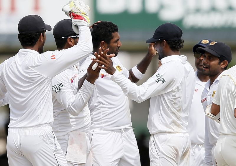 © Reuters. Sri Lanka's Prasad celebrates with his teammates after taking the wicket of Pakistan's Shah during the fourth day of their second test cricket match in Colombo