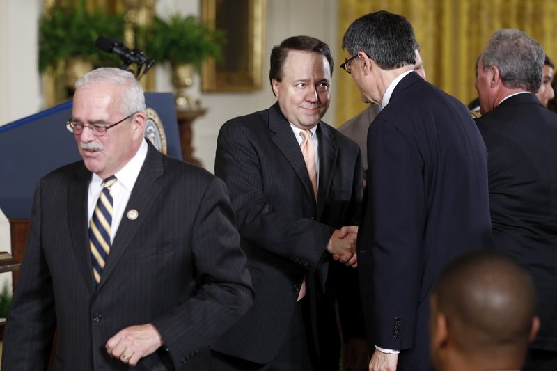 © Reuters. Lew shakes hands with U.S. House members who supported trade legislation,during bill signing ceremony in the East Room of the White House in Washington