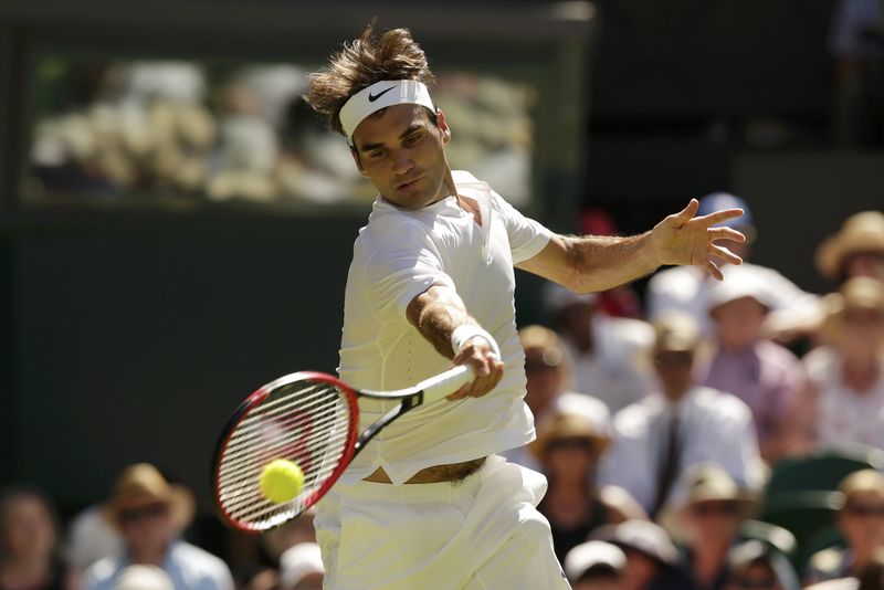 © Reuters. Roger Federer of Switzerland hits a shot during his match against Damir Dzumhur of Bosnia and Herzegovina at the Wimbledon Tennis Championships in London