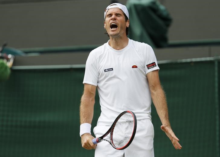 © Reuters. Tommy Haas of Germany reacts during his match against Milos Raonic of Canada at the Wimbledon Tennis Championships in London