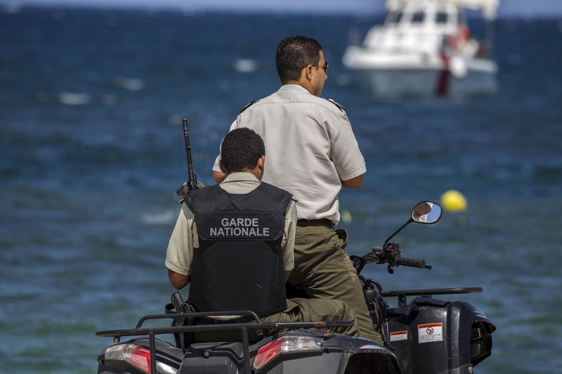 © Reuters. National guard members patrol at the beach near the Imperiale Marhaba hotel, which was attacked by a gunman in Sousse, Tunisia