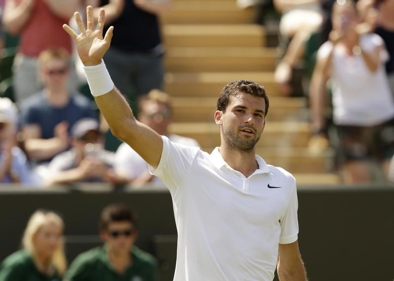 © Reuters. Grigor Dimitrov of Bulgaria celebrates after winning his match against Steve Johnson of the U.S.A. at the Wimbledon Tennis Championships in London