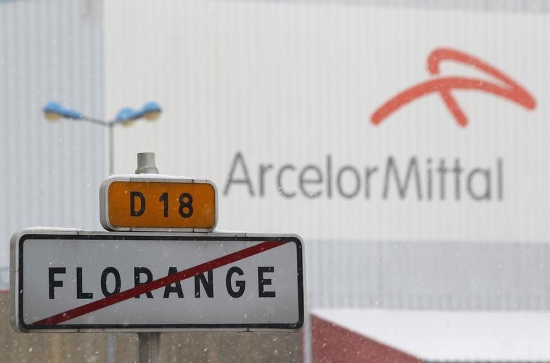 © Reuters. A road sign with the crossed out city name of Florange is seen in front of the ArcelorMittal plant in Florange