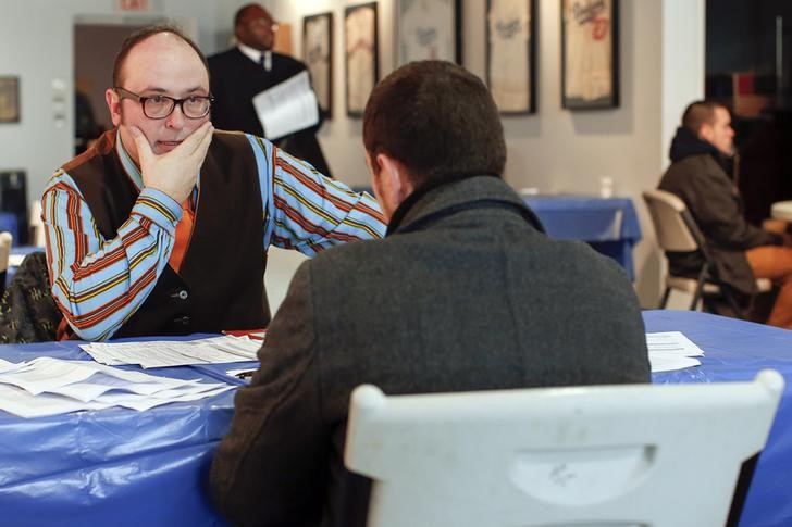 © Reuters. Man listens to a job interviewer during a screening session for seasonal jobs at Coney Island in the Brooklyn borough of New York