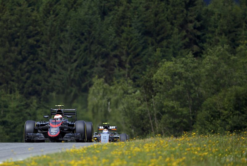 © Reuters. McLaren Formula One driver Button of Britain drives in front of Force India Formula One driver Perez of Mexico during the first practice session of the Austrian F1 Grand Prix at the Red Bull Ring circuit in Spielberg