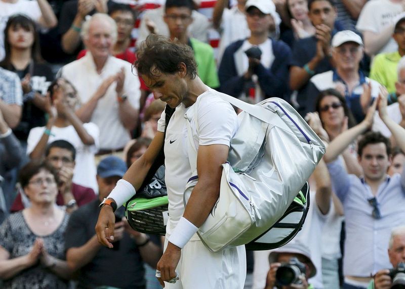© Reuters. Rafael Nadal of Spain prepares to walk off court after losing his match against Dustin Brown of Germany at the Wimbledon Tennis Championships in London