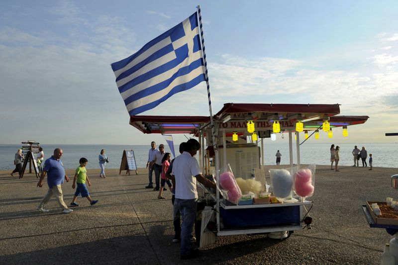 © Reuters. Greek national flag is placed at a stall selling candy floss at the northern city of Thessaloniki