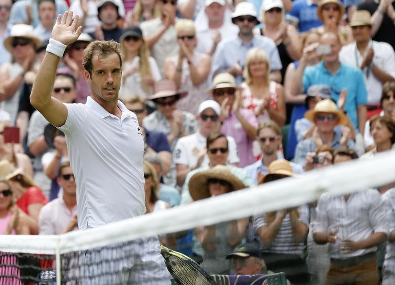 © Reuters. Richard Gasquet of France celebrates after winning his match against Grigor Dimitrov of Bulgaria at the Wimbledon Tennis Championships in London