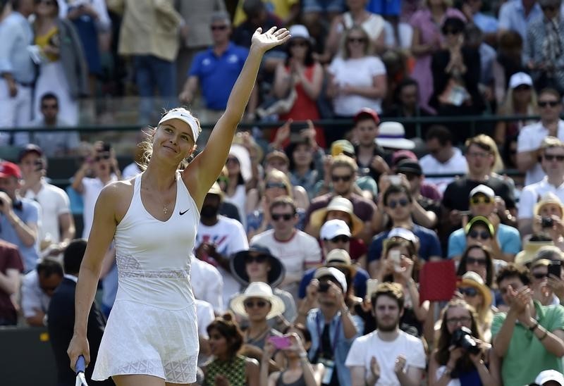 © Reuters. Maria Sharapova of Russia celebrates after winning her match against Irina-Camelia Begu of Romania at the Wimbledon Tennis Championships in London