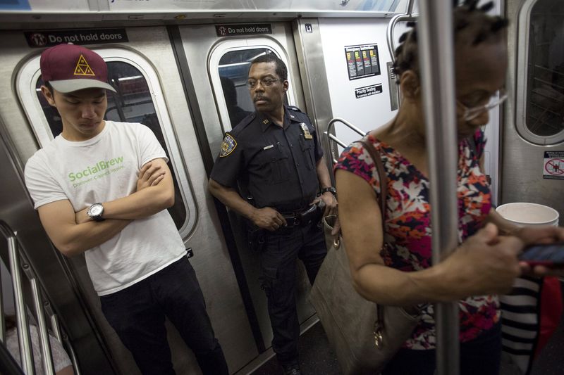 © Reuters. A member of the New York Police Department rides the Subway in New York