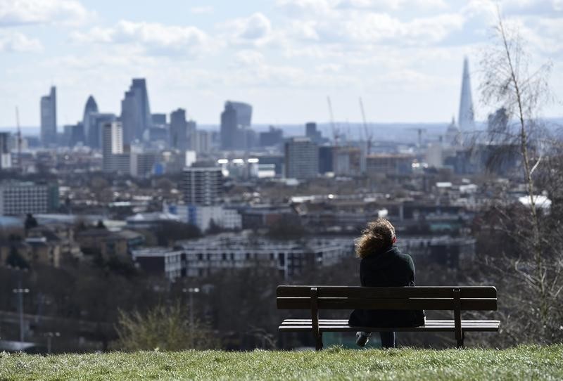 © Reuters. A woman looks towards the City of London financial district from Parliament Hill in north London