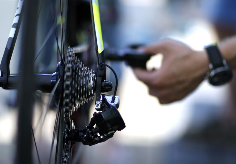© Reuters. A Tinkoff-Saxo mechanic checks a bicycle before a training session in Utrecht