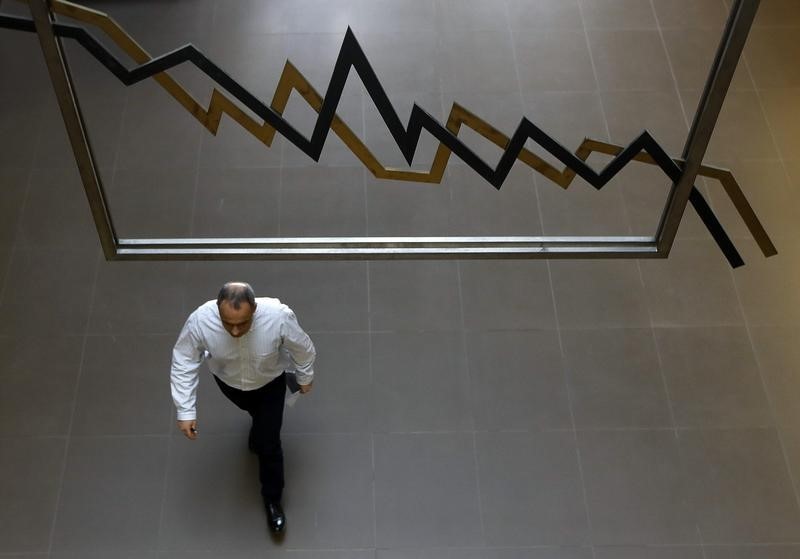 © Reuters. A man walksinside Athens stock exchange  as the general index gains allmost 10 percent