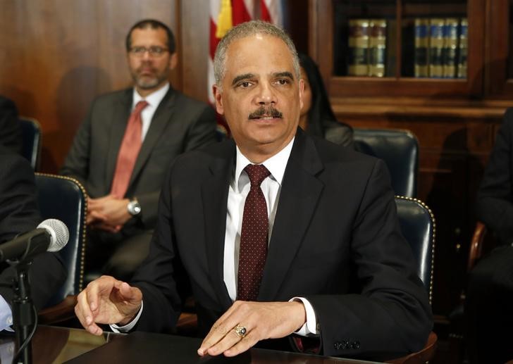 © Reuters. Attorney General Eric Holder talks to the media about the shooting of two police officers in Ferguson