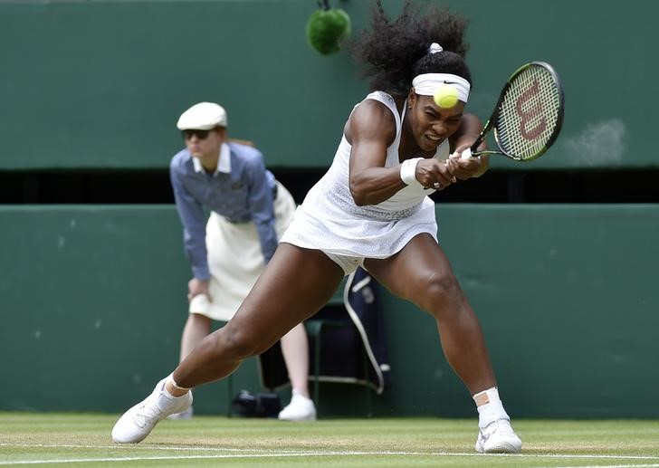 © Reuters. Serena Williams of the U.S.A. hits a shot during her match against Venus Williams of the U.S.A. at the Wimbledon Tennis Championships in London